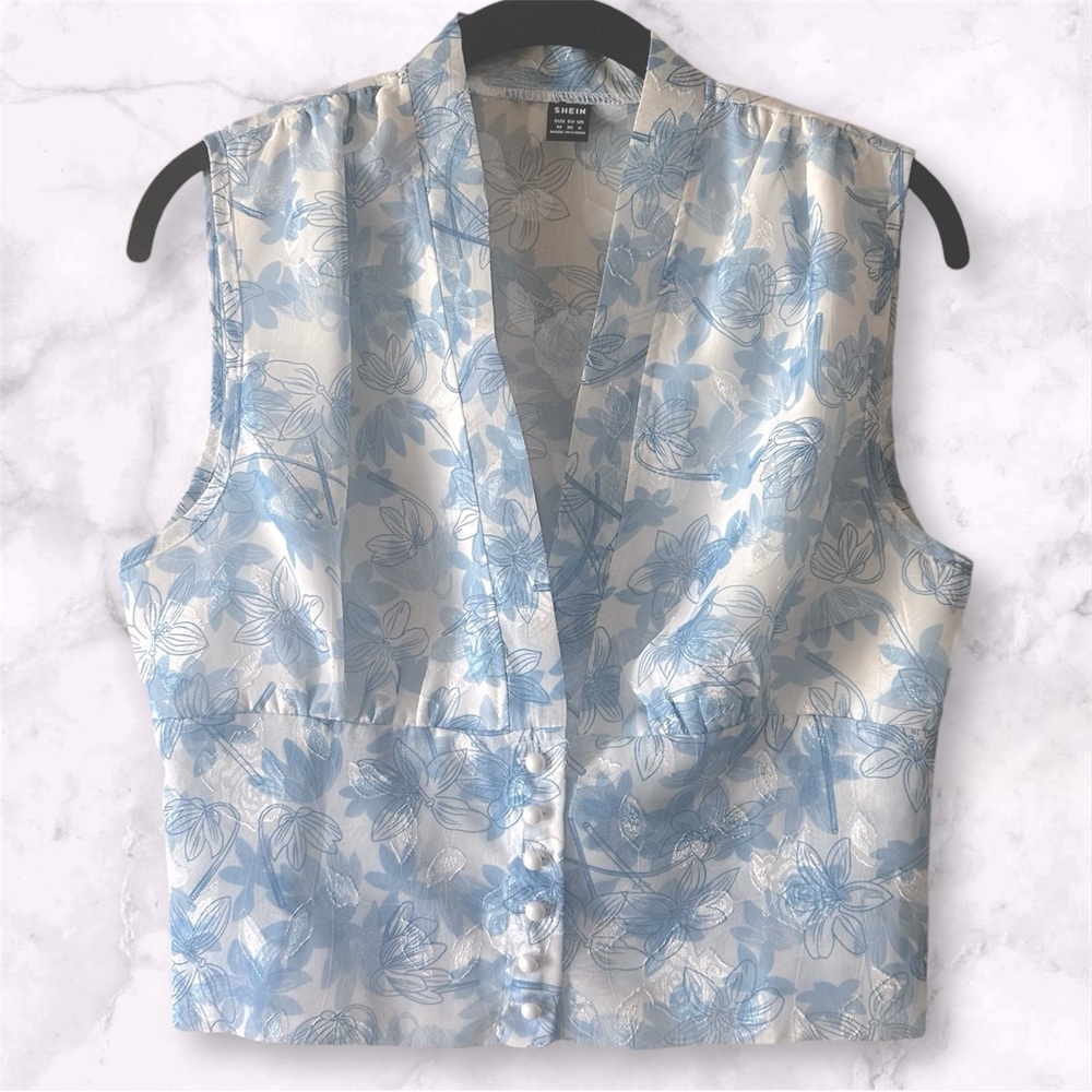 Blue and white floral blouse with button-up front and pearl buttons